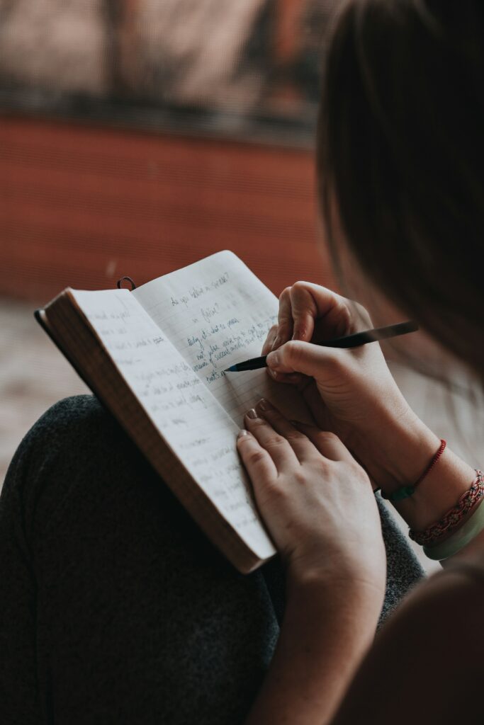 A woman journaling for recovery